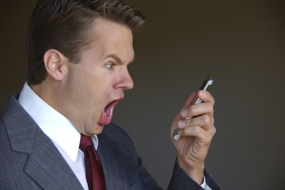 man yelling shouting screaming at cell phone