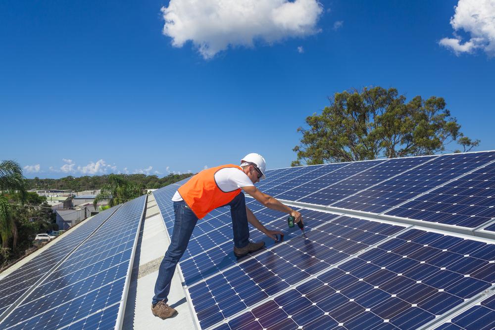 man installing solar panels