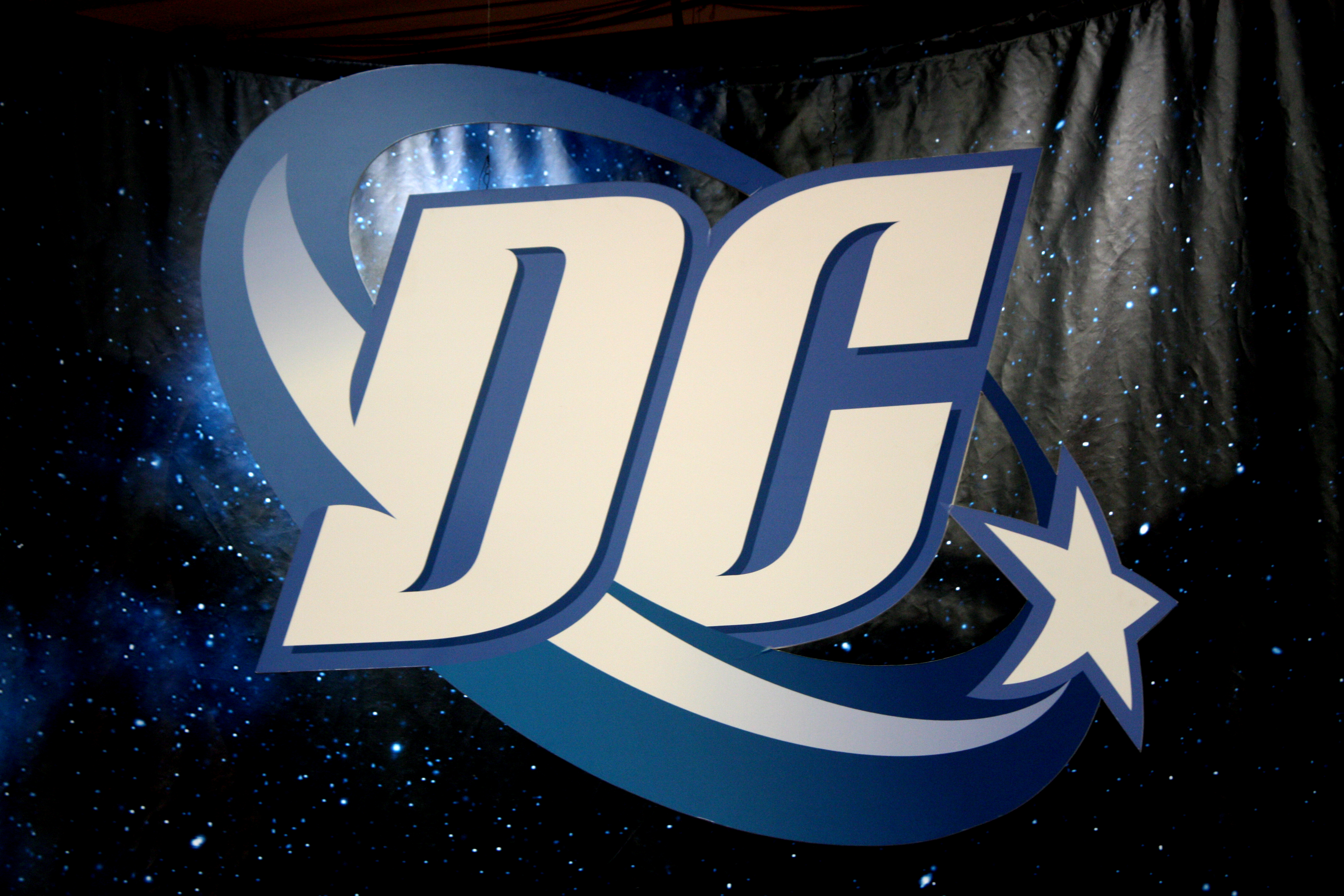 dc comics and warner brothers working on film with blue beetle booster gold logo