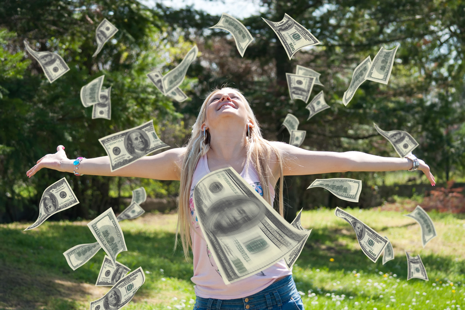 a blonde woman throwing money in the air on a sunny day