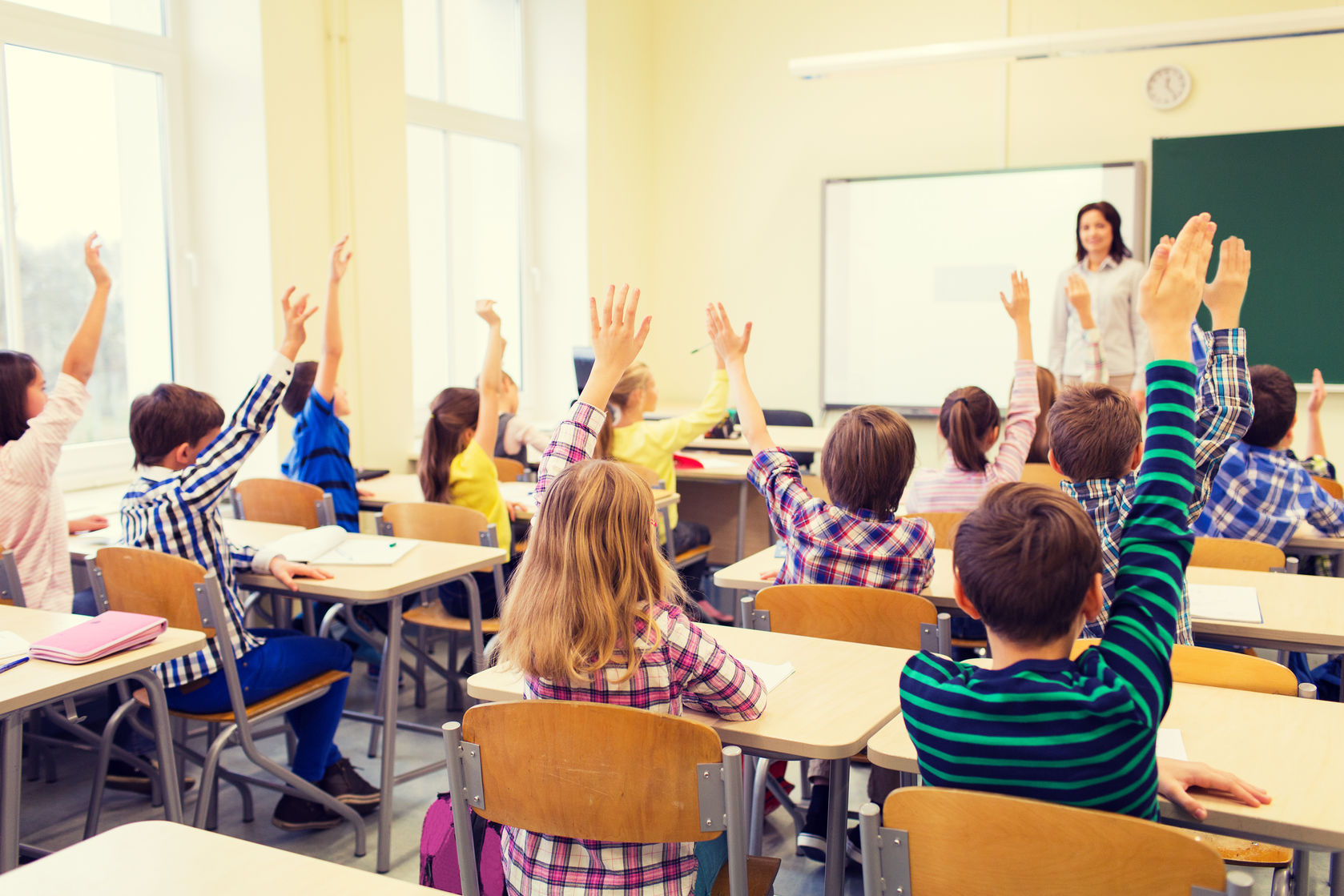 robot tutor emotional states group of school kids with teacher sitting in classroom and raising hands