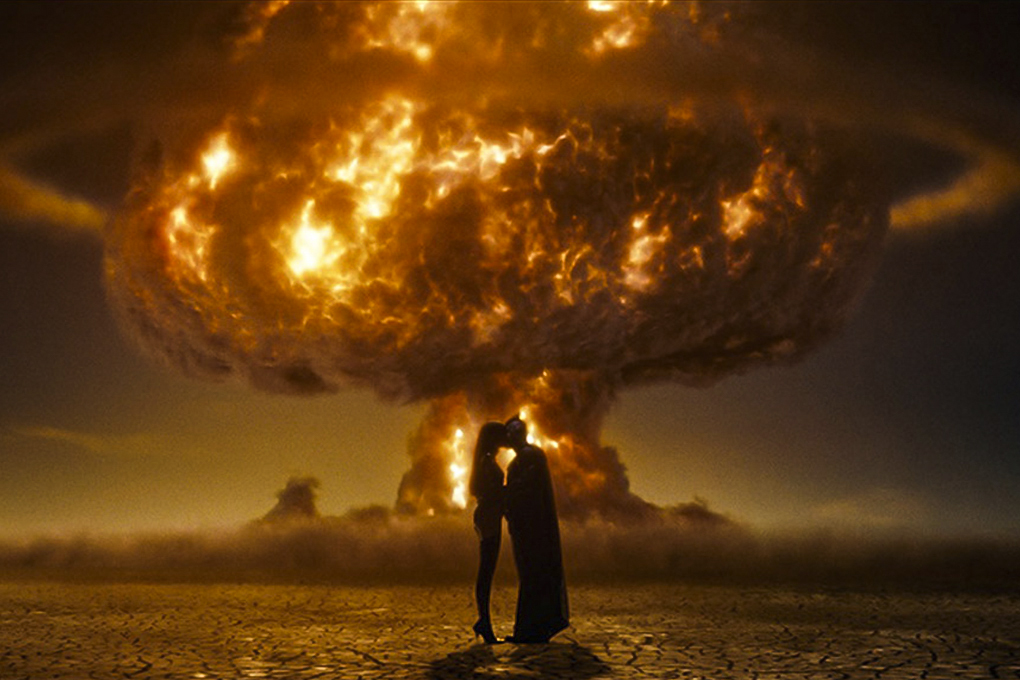 Nite Owl and Silk Specter in front of a nuclear explosion in "Watchmen."