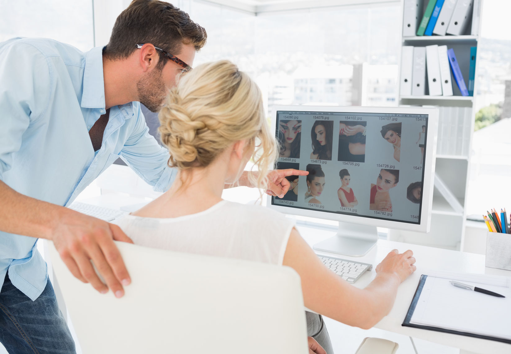 dreamstime ai photo editor 27072305  rear view of editors working on computer in a bright office