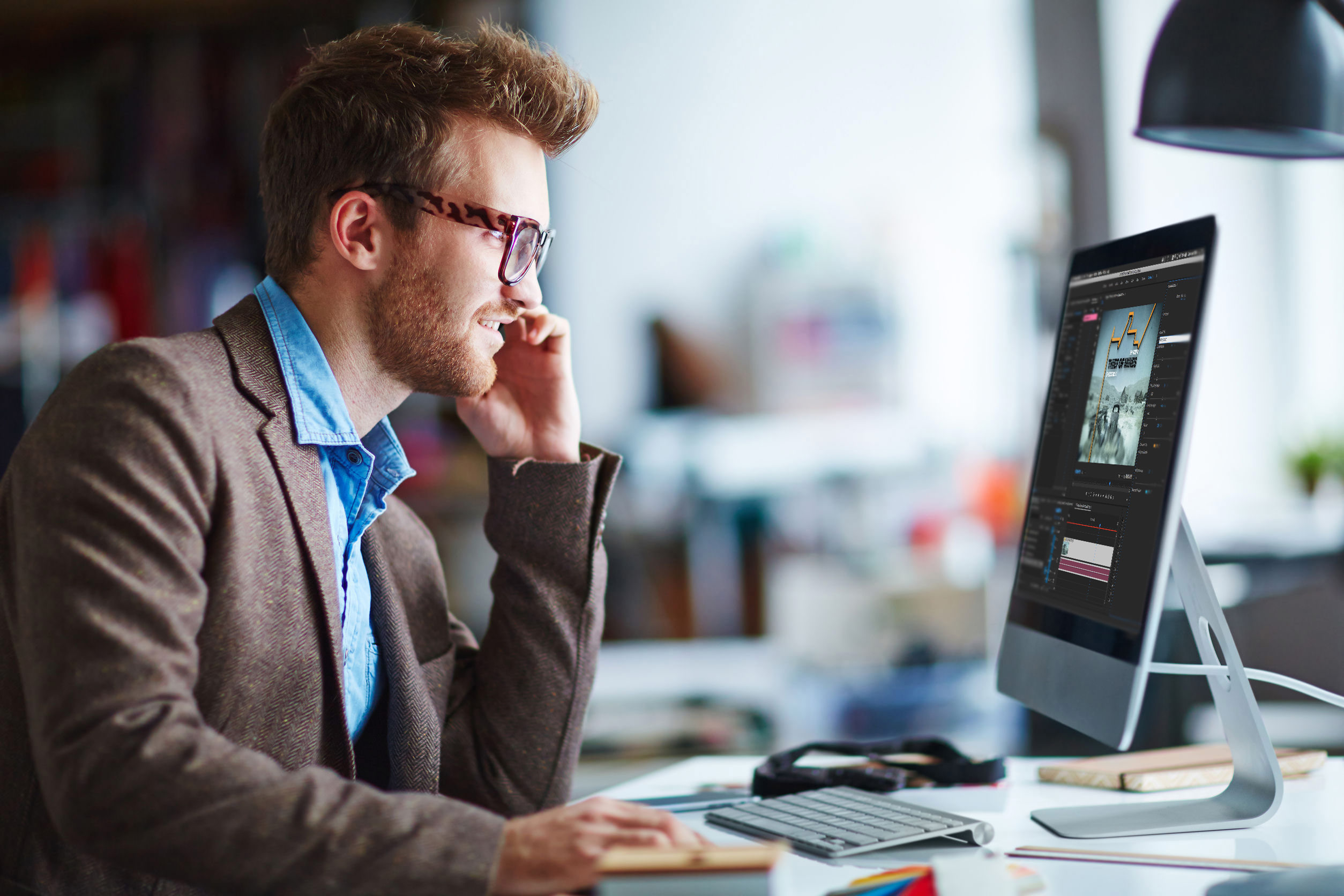 Man using Adobe Premiere Pro on iMac