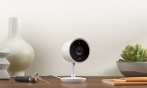 Nest Cam IQ sitting on a desk next to car keys and books