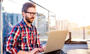 storyblocks creative survey generations businessman working from home on laptop  sitting balcony