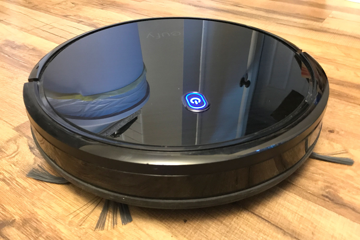 The Eufy RoboVac 11S robot vacuum on the floor.