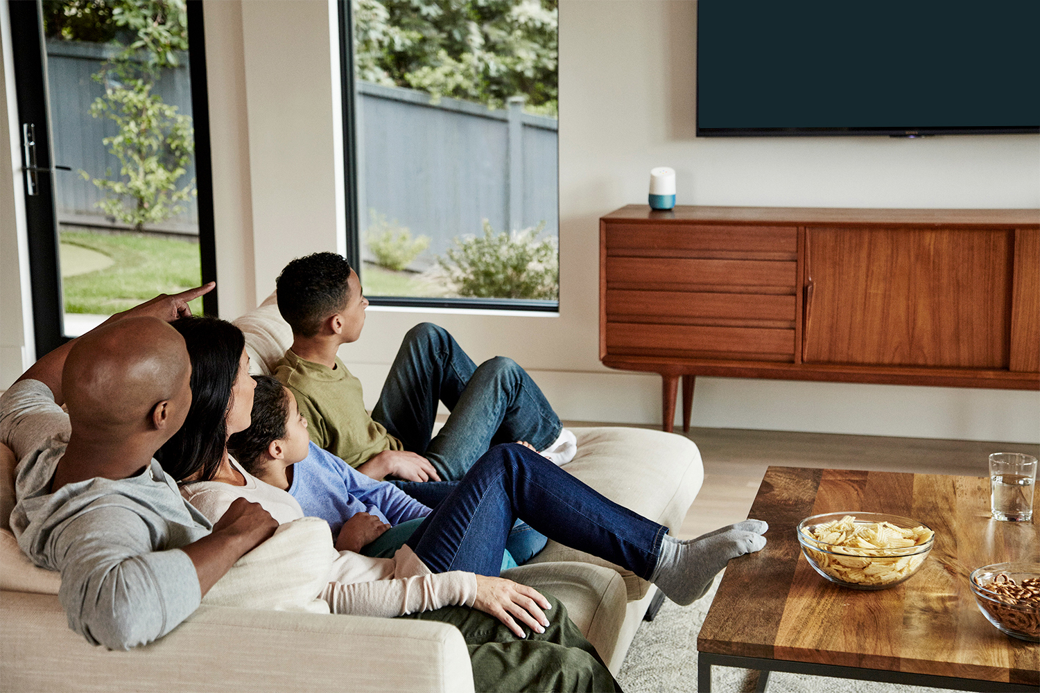 family watching tv with google home