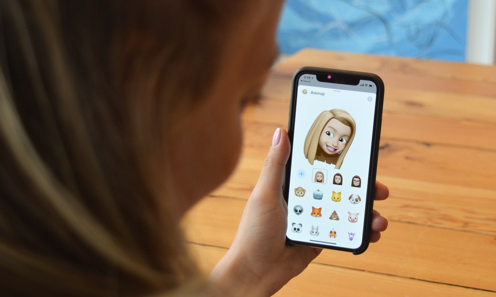 apple iphone 13 vs 12 memoji on in hand