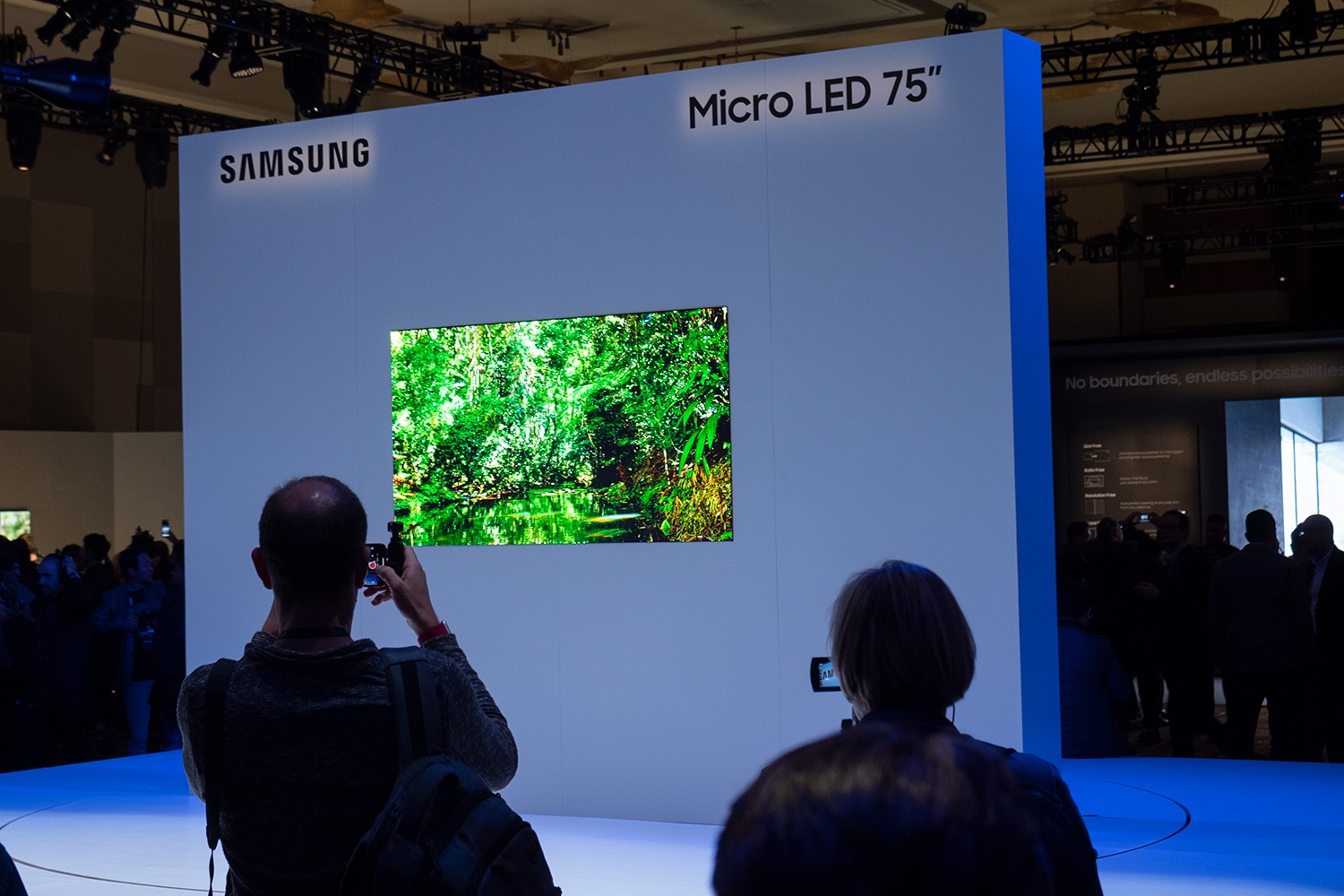 Viewers examine a Samsung Micro LED 75-inch TV on display.