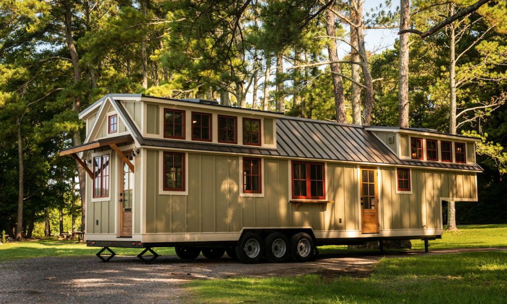 A 42ft Denali XL Tiny House by Timbercraft Tiny Homes set up in the woods.