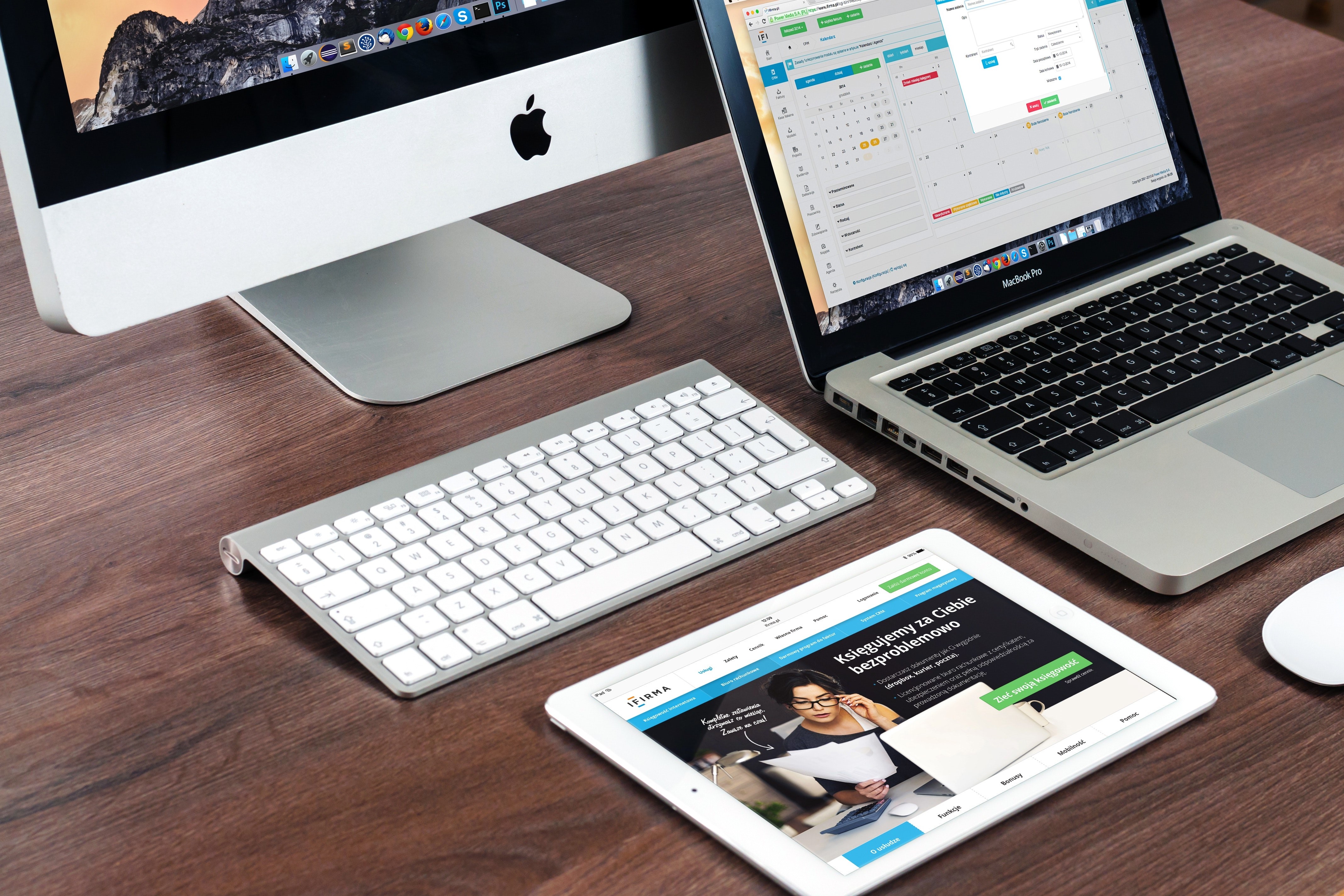 A stock photo of group of Apple products sitting on a table