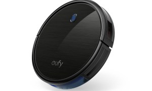 The slim version of the Eufy BoostIQ Robovac 11s, with the power button glowing faintly.