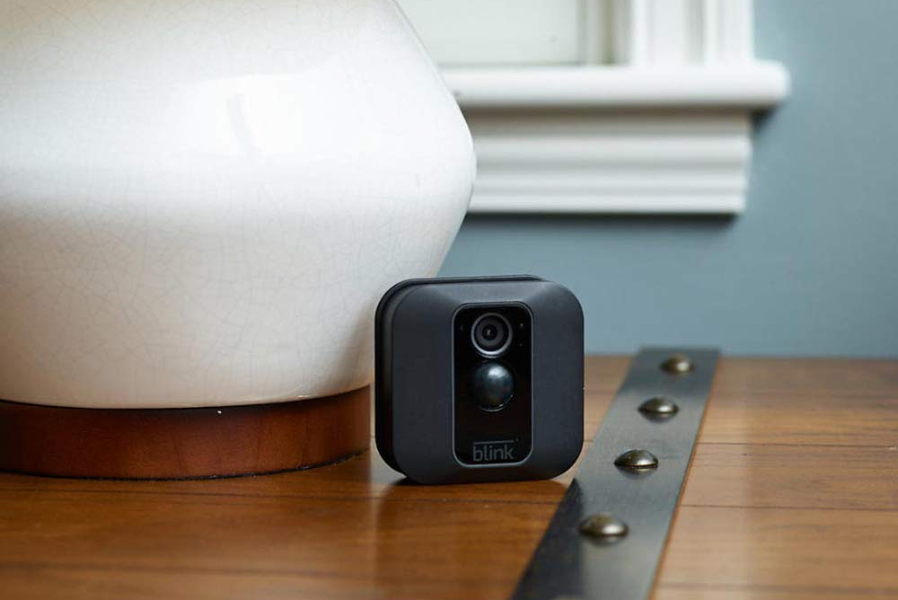 A Blink XT2 Smart Security Camera on an end table.