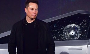 Tesla co-founder and CEO Elon Musk stands in front of the newly unveiled all-electric battery-powered Tesla's Cybertruck