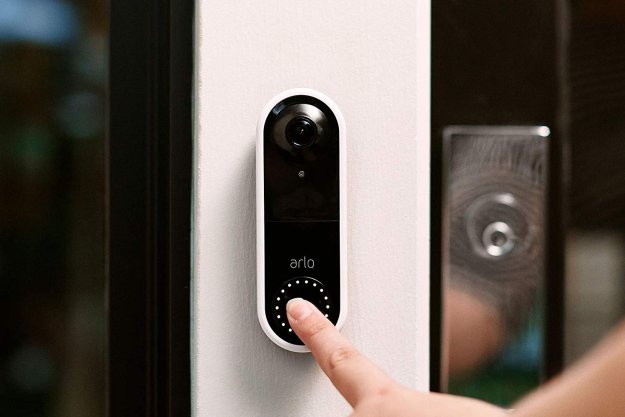 A person pressing the Arlo Video Doorbell.