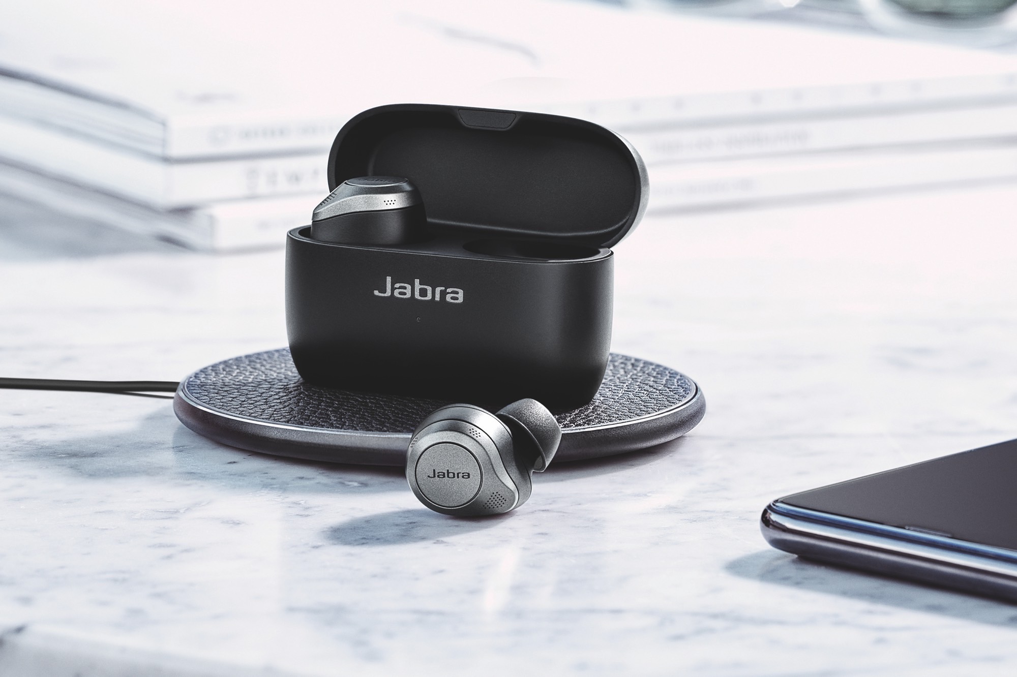 Jabra Elite 85t on a wireless charging mat.