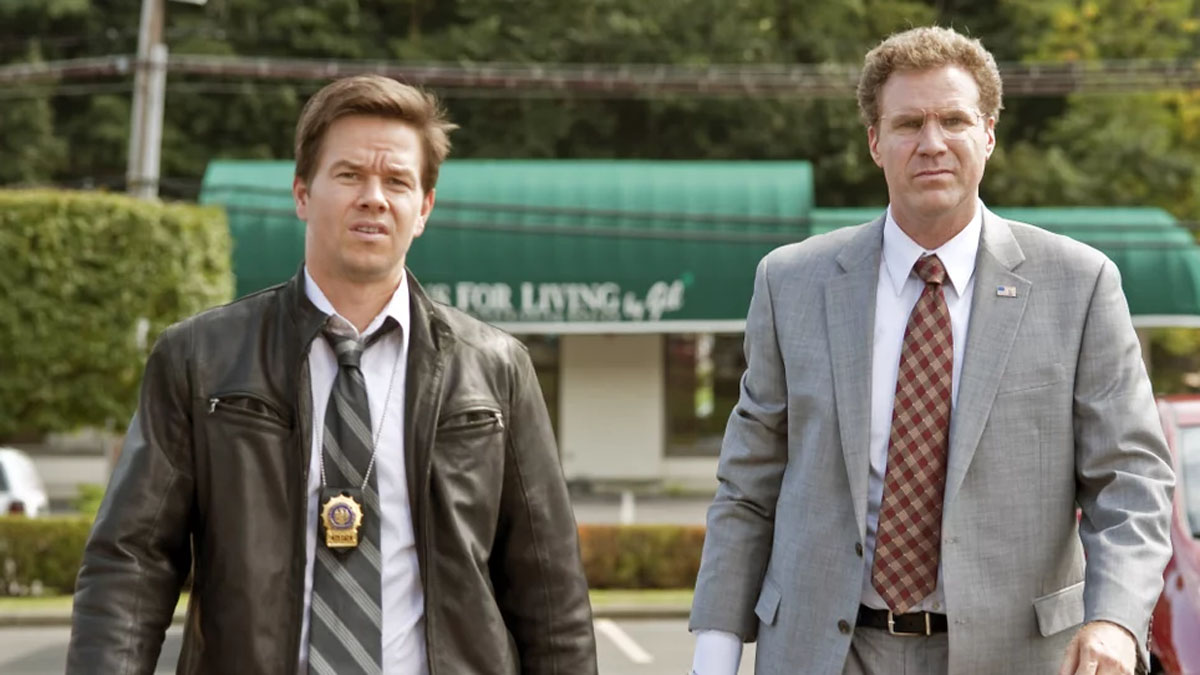 Mark Wahlberg and Will Ferrell stand next to each other in The Other Guys.