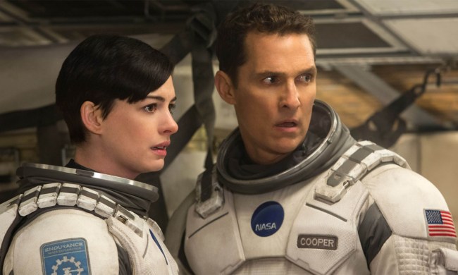 Matthew McConaughey and Anne Hathway curiously stare next to each other in a scene from Interstellar.