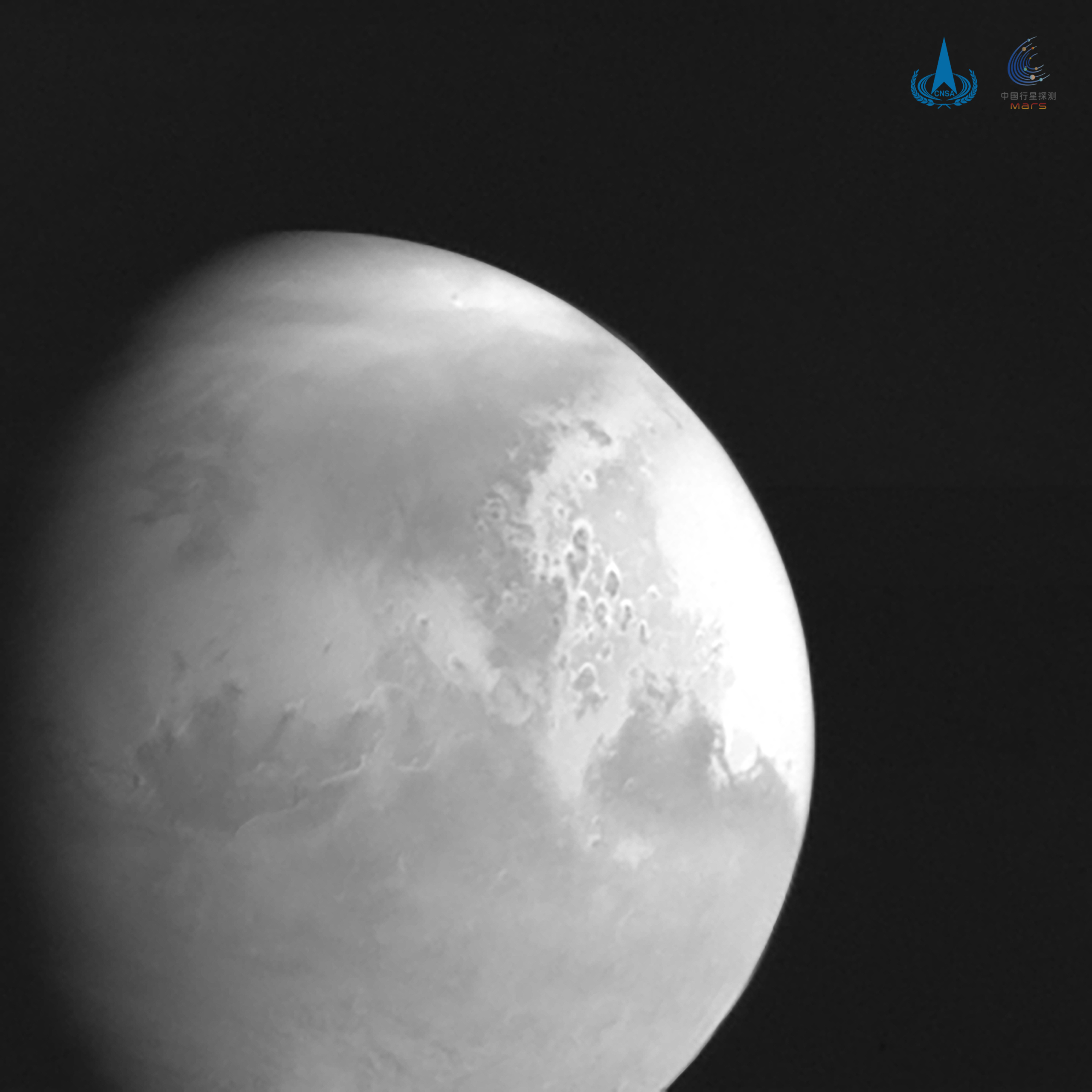 A black-and-white picture of Mars taken by Tianwen 1, the first snapshot from the Chinese craft.