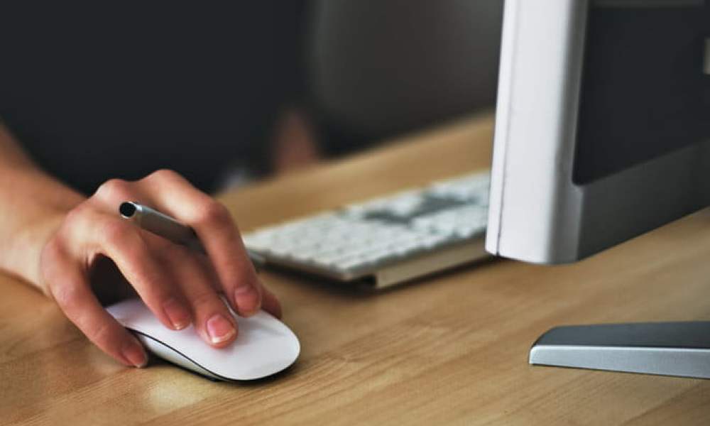 Apple Magic Mouse on a desk.