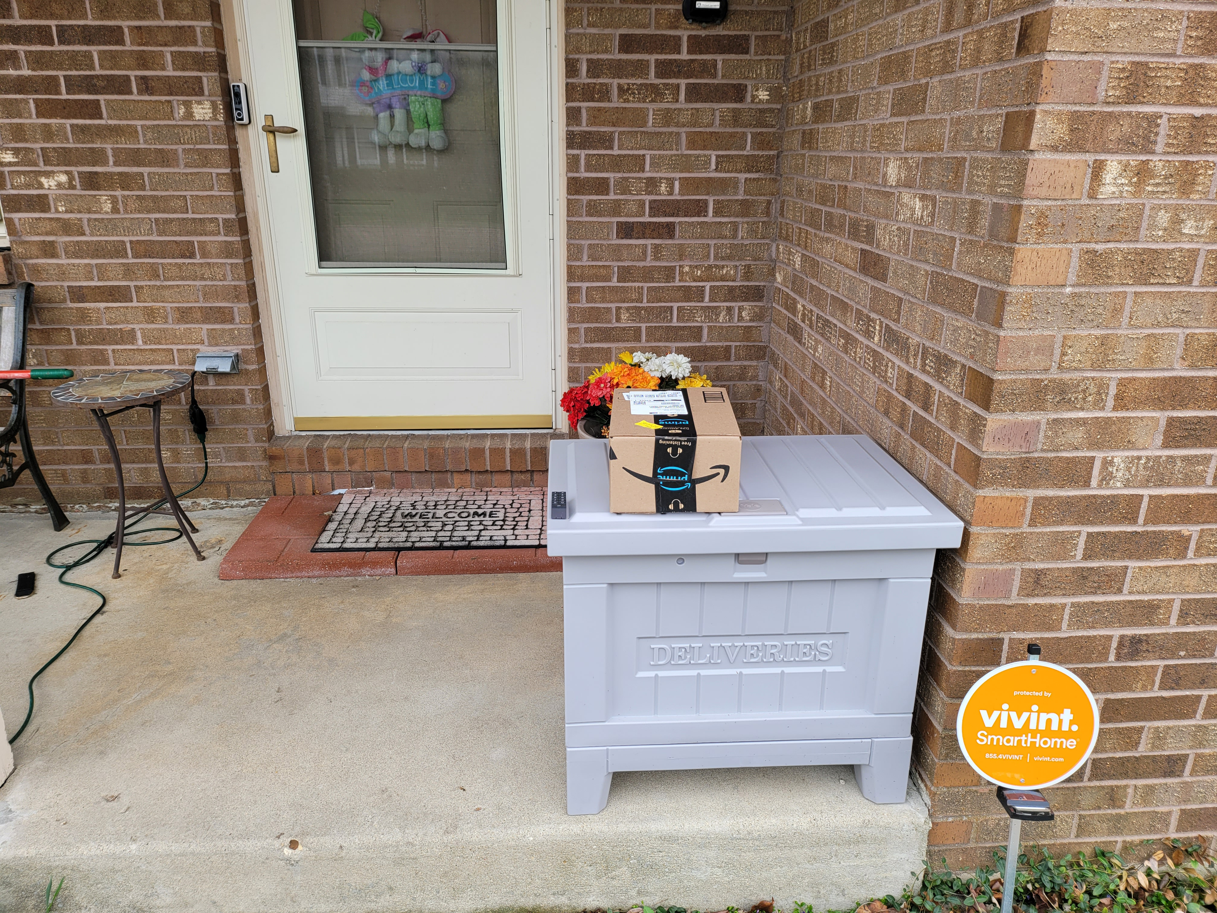 An Amazon package sits on top of the Yale Smart Delivery box,.