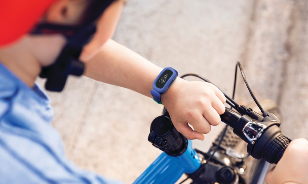 A kid wearing the Fitbit Ace 2.