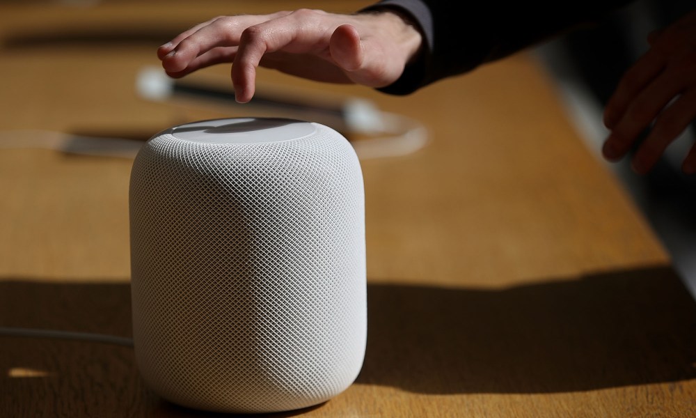 Customers inspect the new Apple HomePod at an Apple Store on February 9, 2018 in San Francisco, California.