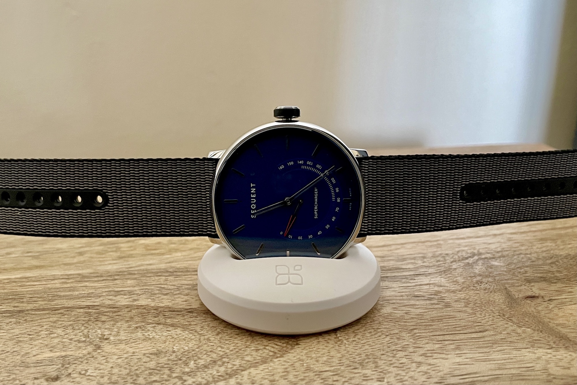 Sequent SuperCharger watch on its charging plinth.