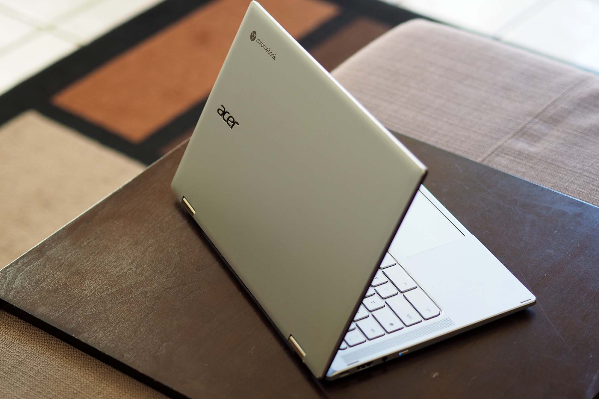 An Acer Chromebook Spin 514 sitting on a table (backside view).