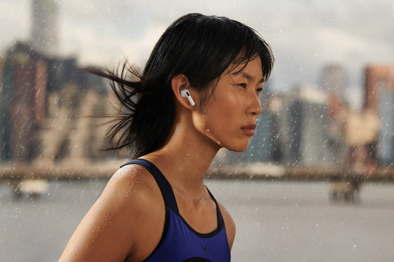 Woman running while wearing the new Airpods 3rd Gen.