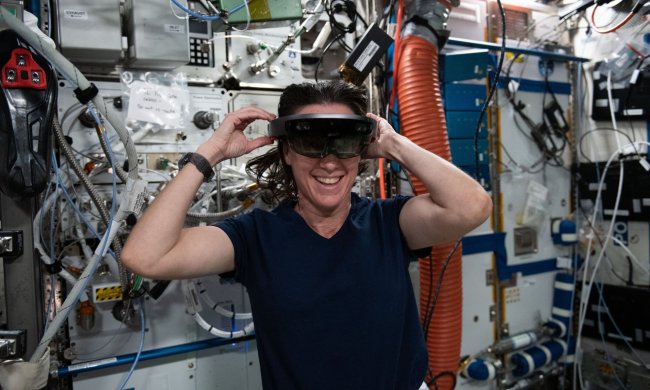 NASA Astronaut Megan McArthur dons a Microsoft HoloLens, a mixed reality (or augmented reality) headset, which allows her to see both the spacearound her as well as digital displays in her field of view.