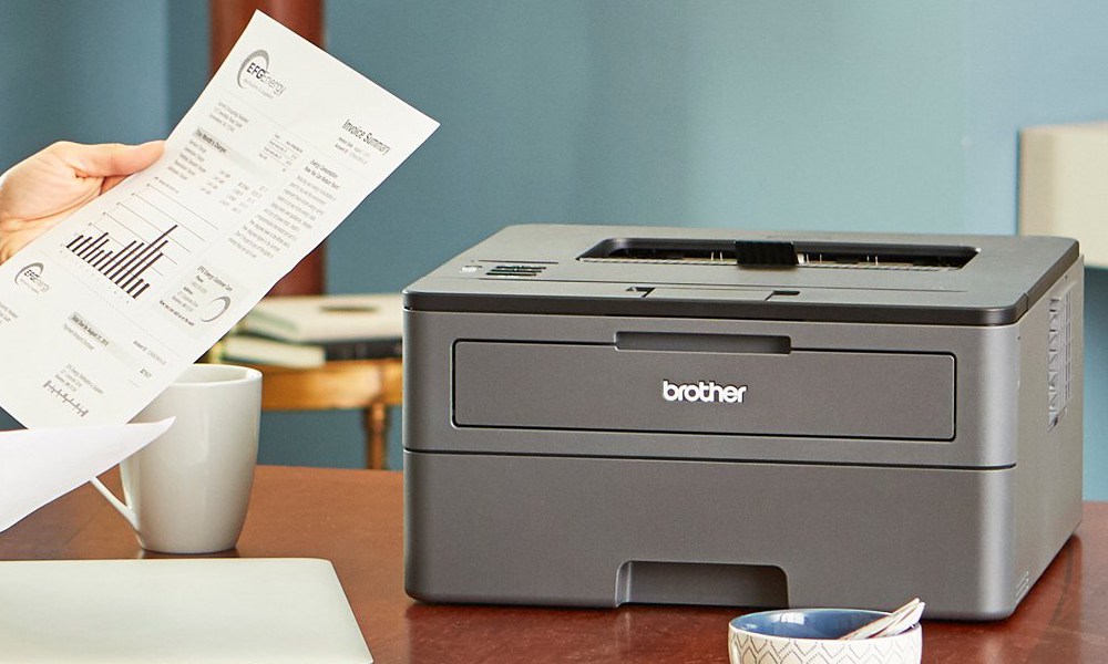 Brother HL-L2325DW Monochrome Laser Printer on a desk.