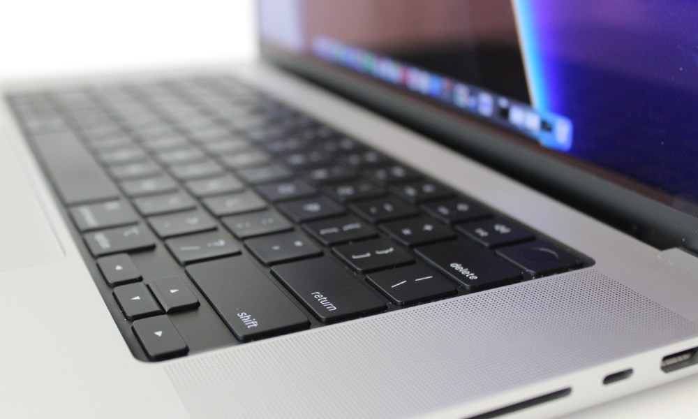 Apple MacBook Pro side view showing keyboard deck and ports.