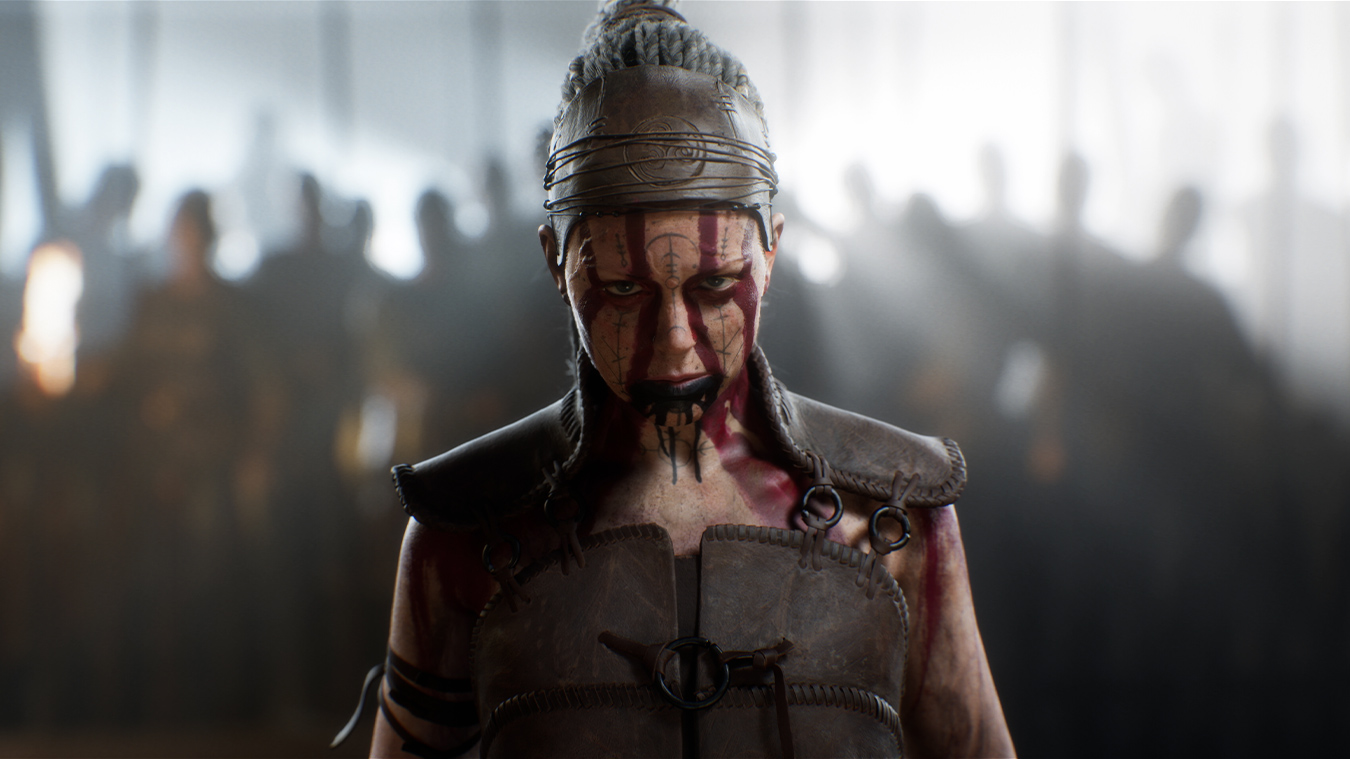 Senua stares ahead wearing war paint.