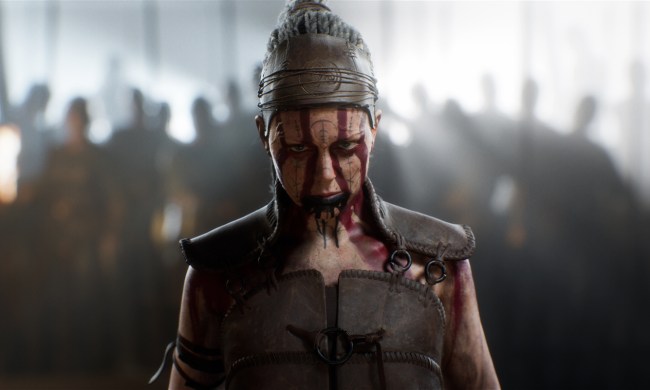 Senua stares ahead wearing war paint.