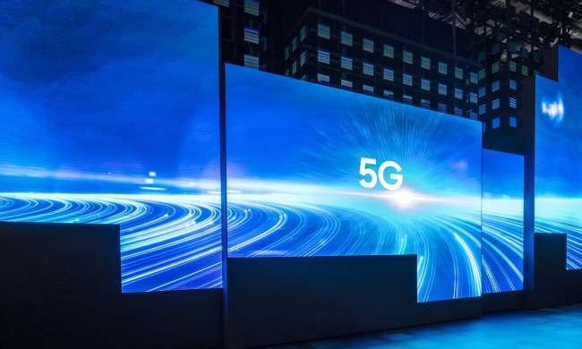 Blue panels showing 5G logo at CES booth.