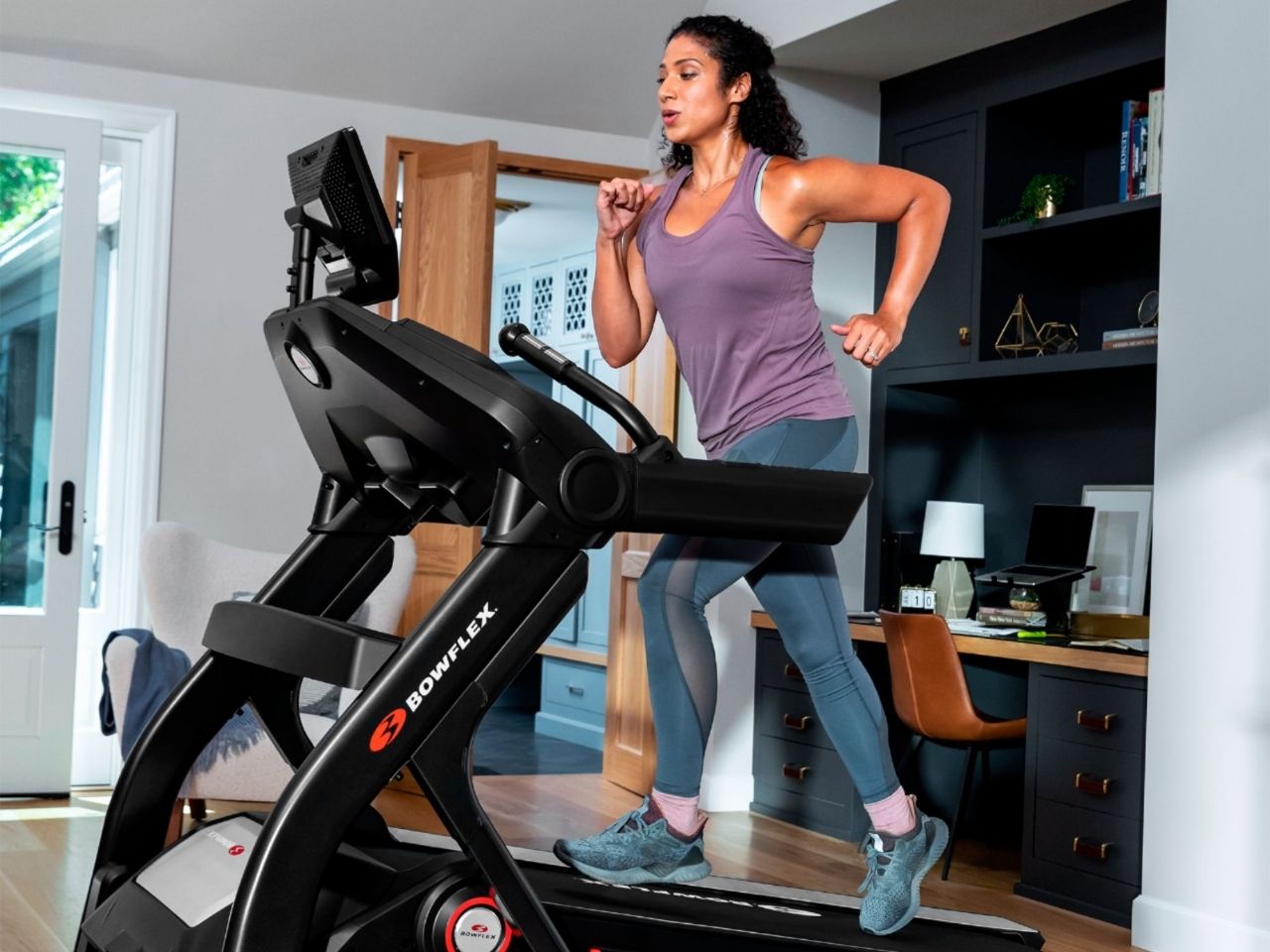 Woman running on a Bowflex Treadmill 10.