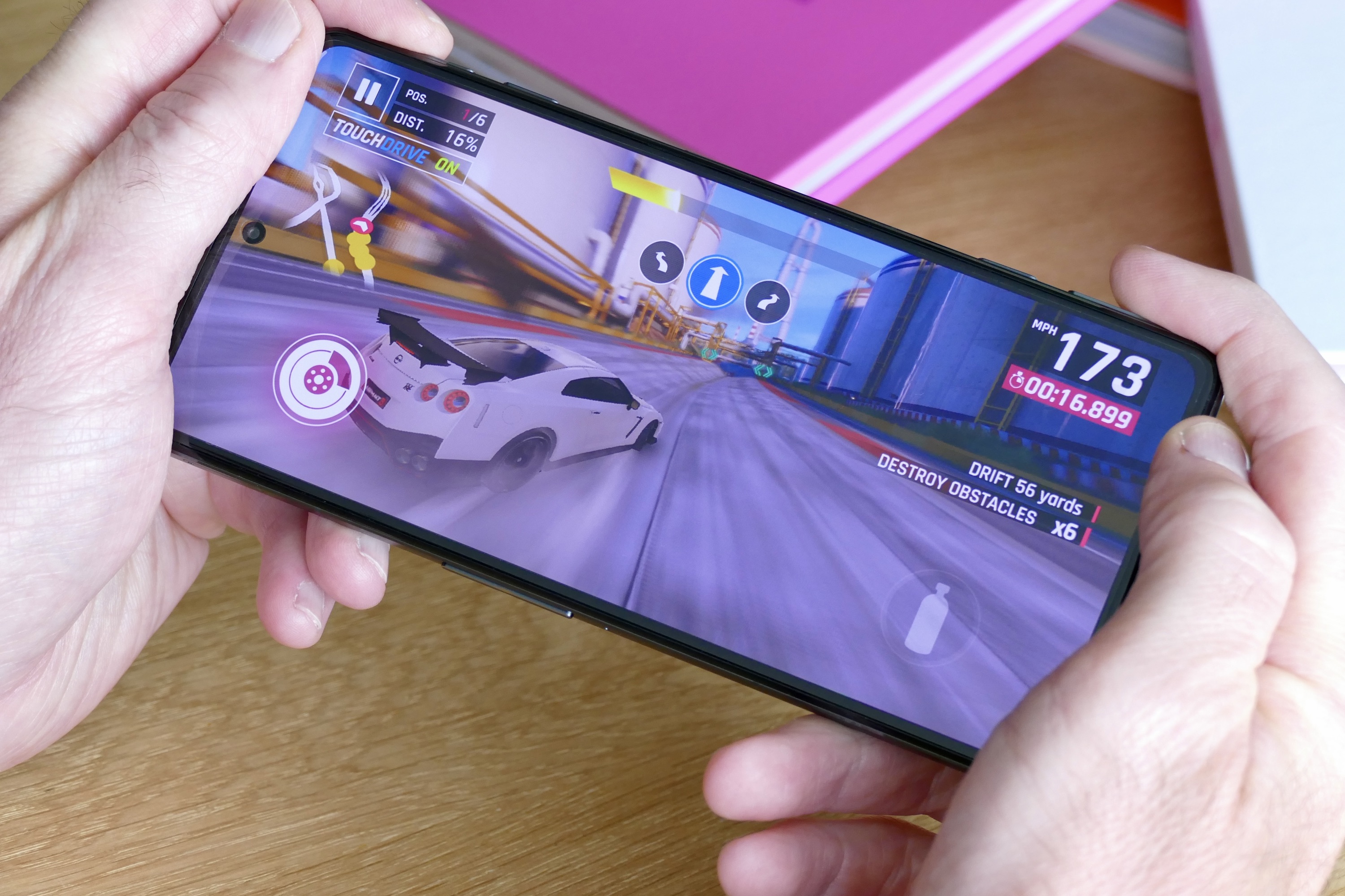 Man playing Asphalt 9: Legends on the Poco F4 GT.