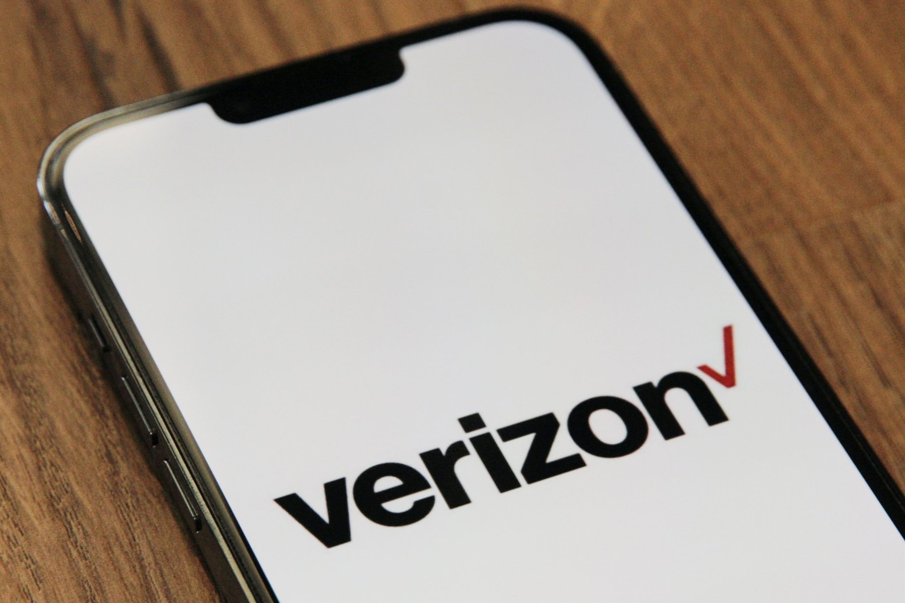 Verizon banner splashed across iPhone screen.