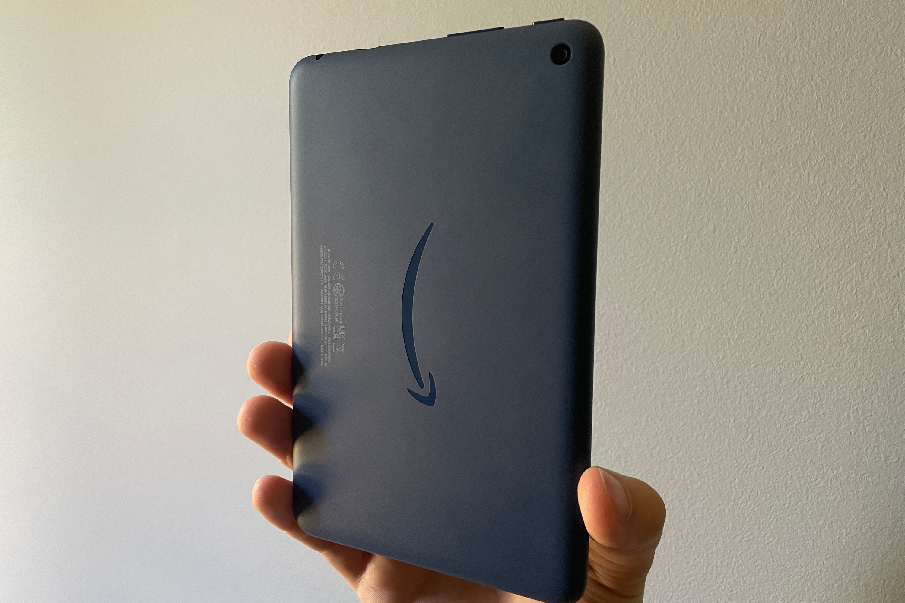 2022 Amazon Fire 7 held vertically with the back facing forward showing off the Amazon arrow logo.