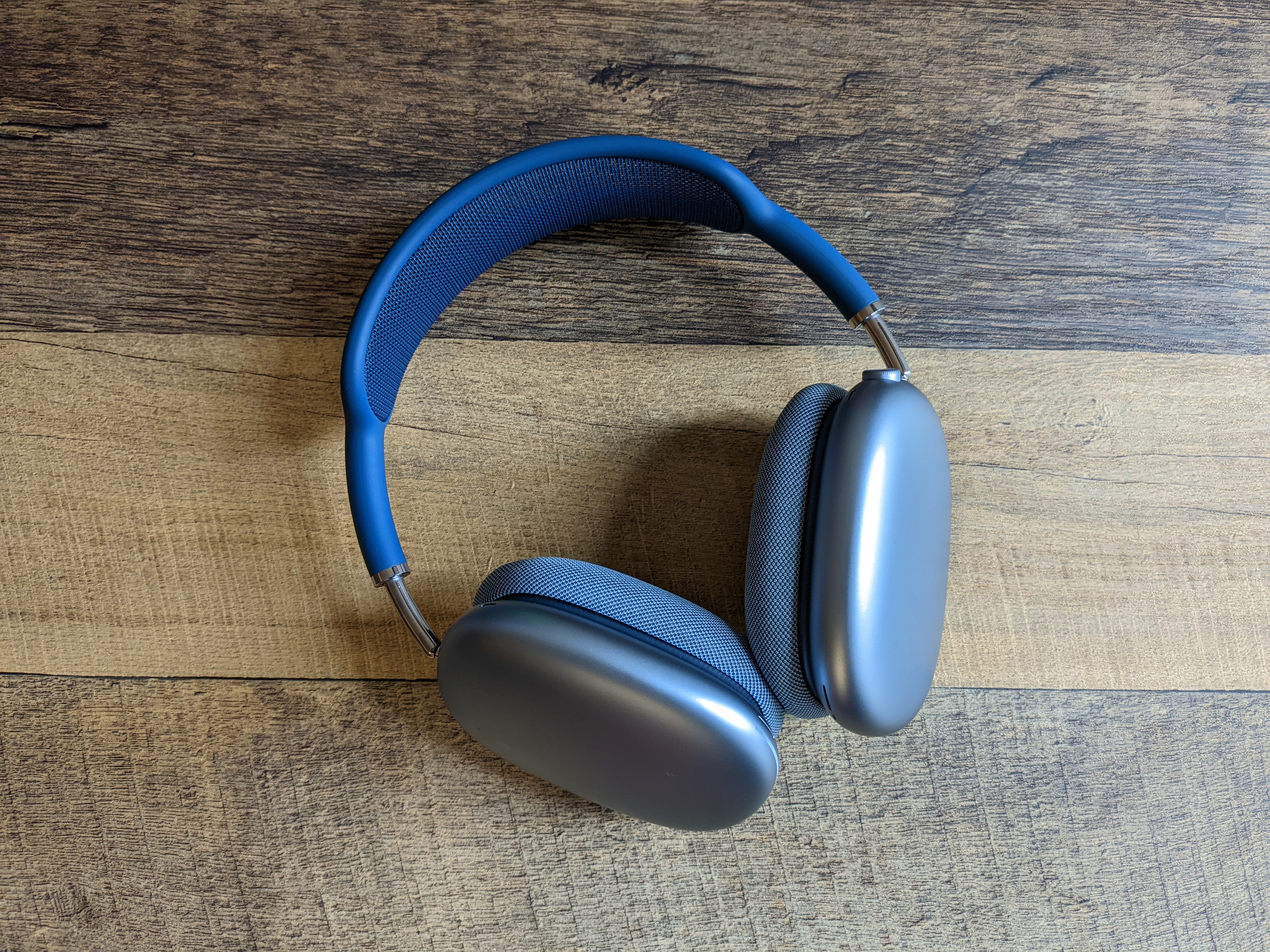 A pair of blue AirPods Max sitting on a table.