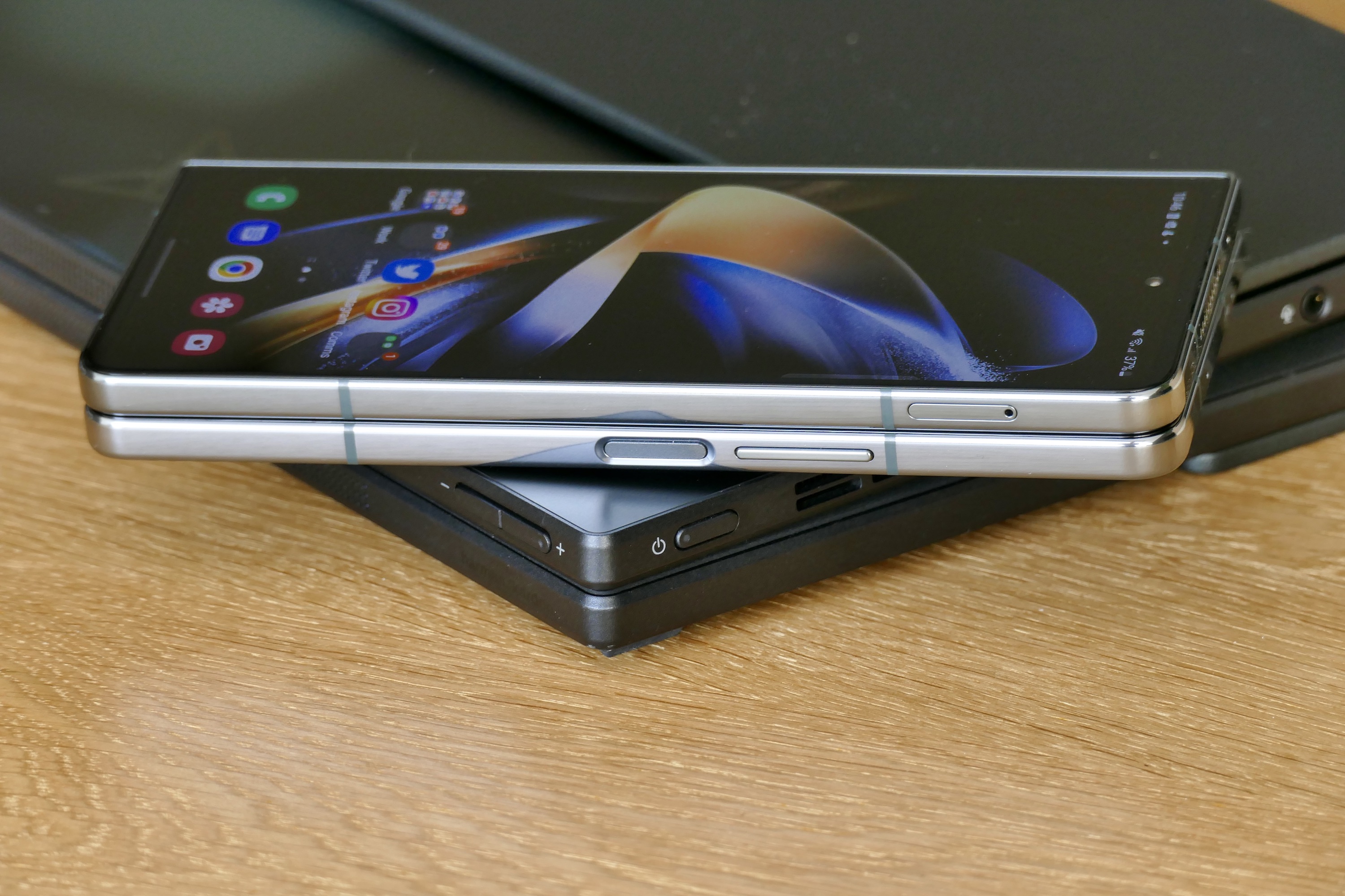 The Asus Zenbook Fold 17's side buttons, seen with the closed Galaxy Z Fold 4.