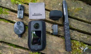 The Insta360 X3 with accessories on a picnic table.