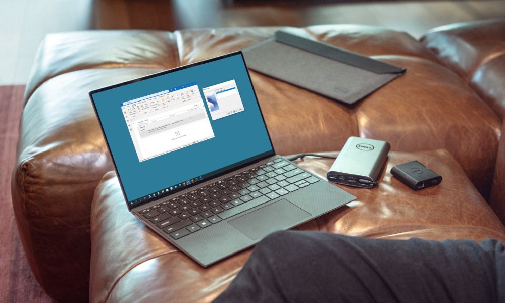 A Dell laptop connected to a hard drive on a couch.