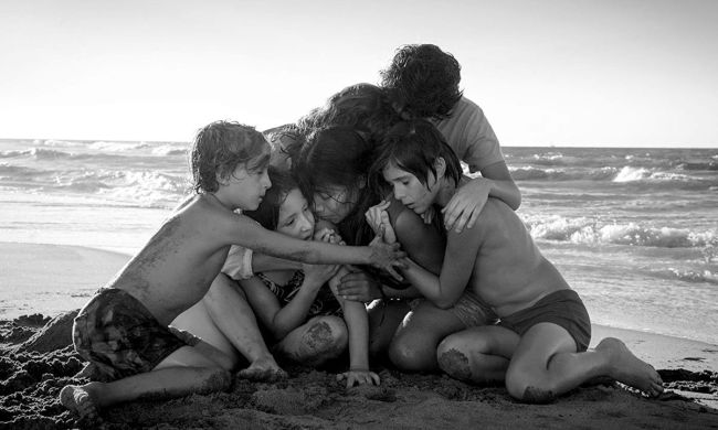 Characters hugging each other in the 2018 film Roma.