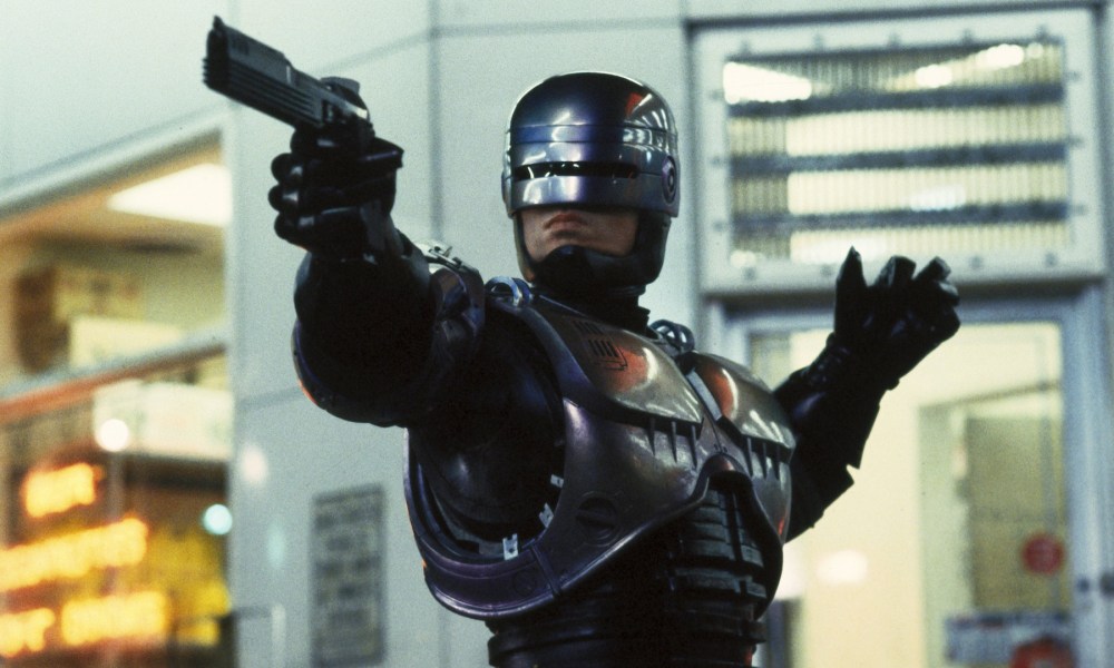 Peter Weller pointing a gun at something offscreen in RoboCop.