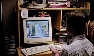 A male teenager sits at a computer in V/H/S/99.