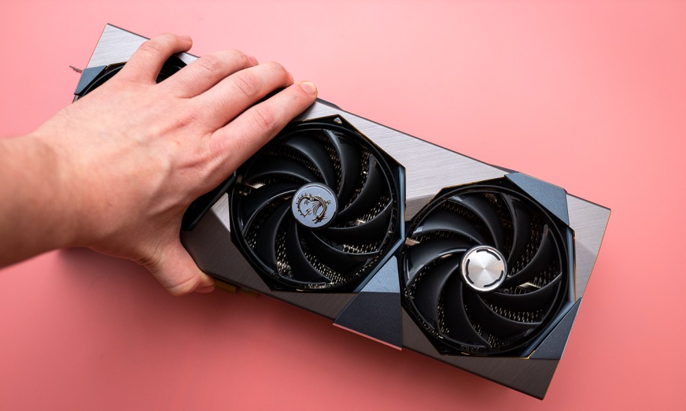 A hand grabbing MSI's RTX 4090 Suprim X.