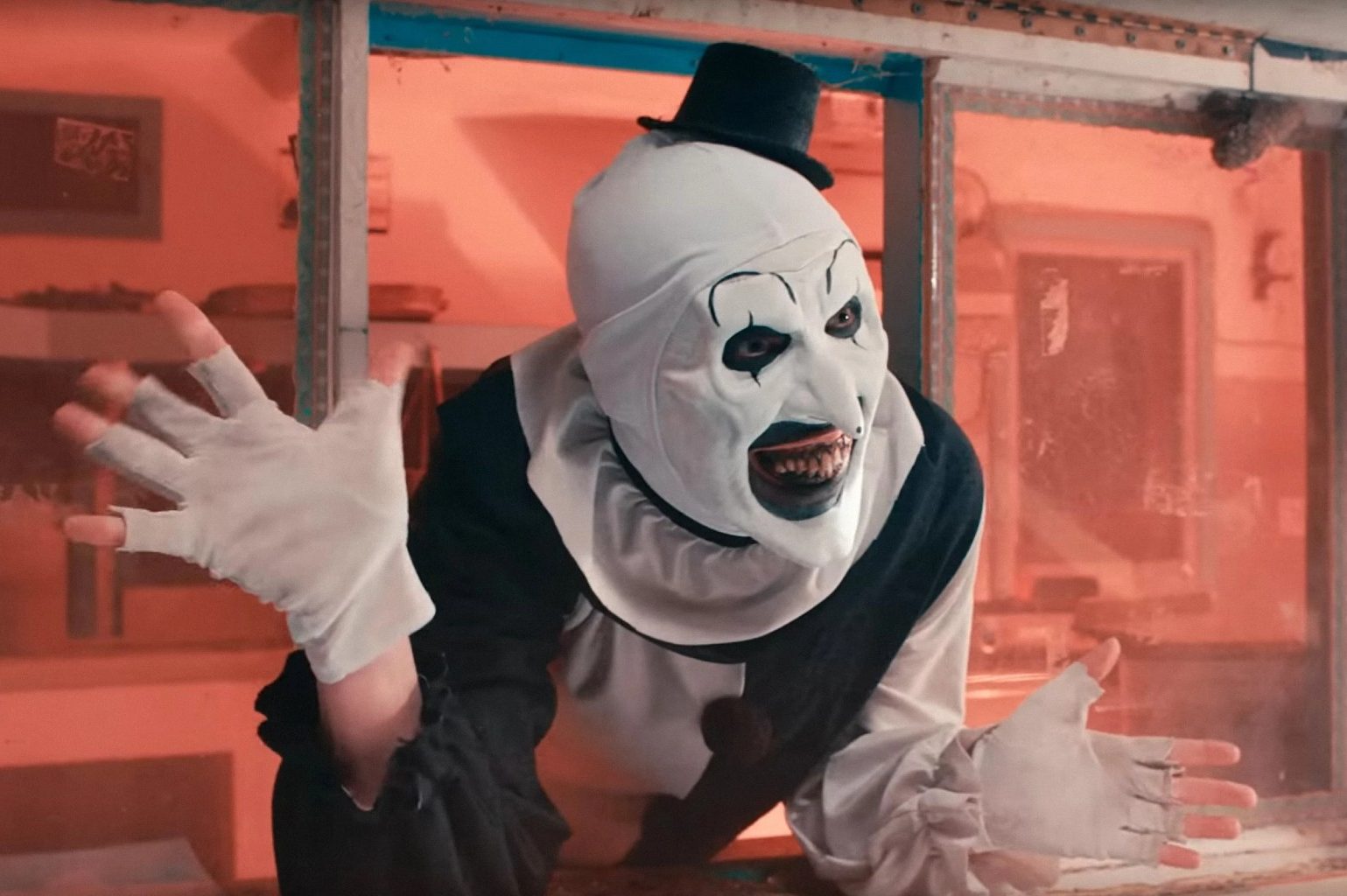 Art the Clown waves his hands in Terrifier 2.